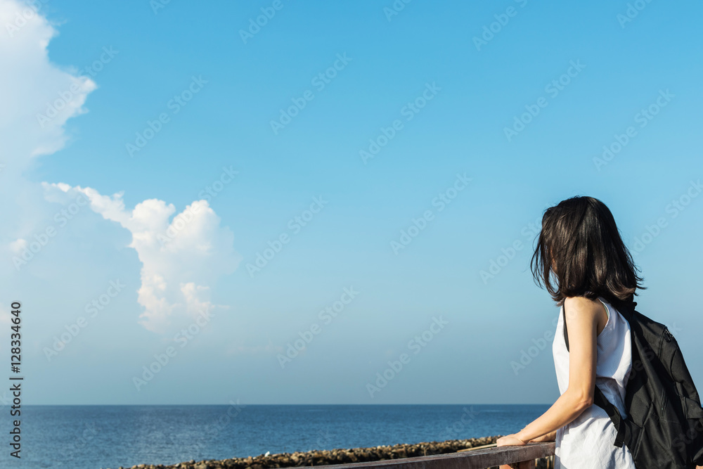 pretty asian girl relax with blue sky, freedom and travel concep