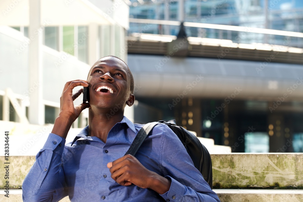 Young african man talking on mobile phone and smiling Young african man talking on mobile phone and smiling