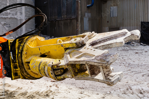 Excavator working at the demolition of an old industrial buildin