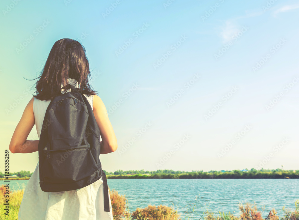 Pretty young woman travel along road by hitchhiking Pretty young woman travel along road by hitchhiking