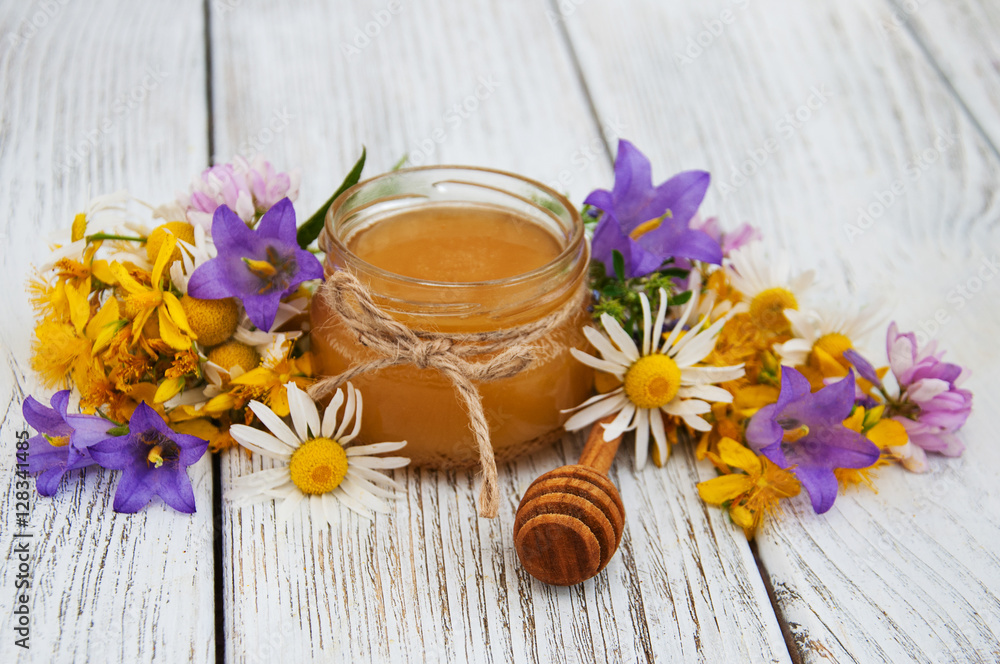 Jar of honey with wildflowers Jar of honey with wildflowers