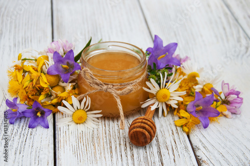 Jar of honey with wildflowers