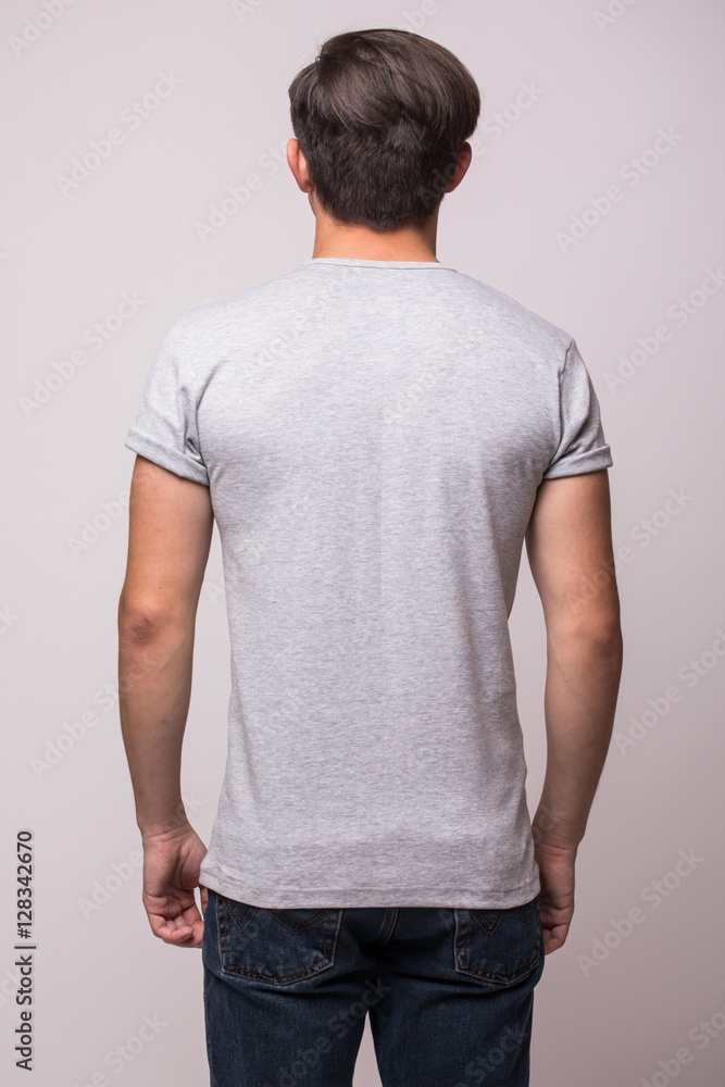 Obraz premium Back part t-shirt on a young man isolated
