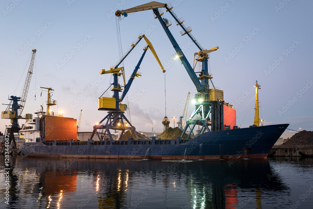 Fototapeta premium general cargo vessel in harbor at dusk