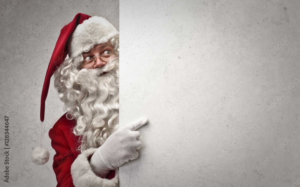 Santa Claus indicating a white cardboard - obrazy, fototapety, plakaty 