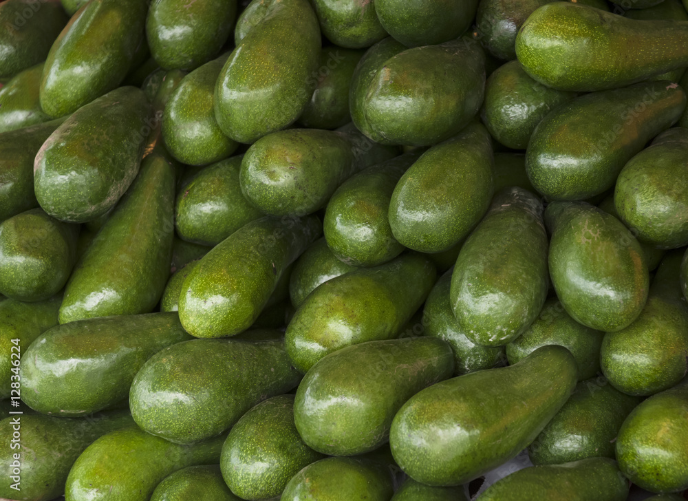 Avocado background. Fresh green avocado on a market. Food background.(selective focus) Avocado background. Fresh green avocado on a market. Food background.(selective focus)