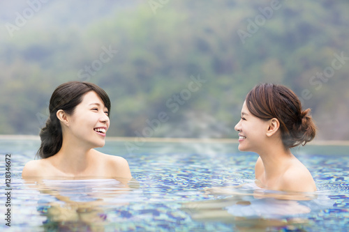 happy young woman relaxing in hot springs