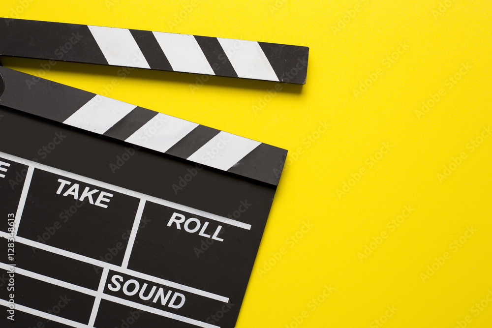 Naklejka premium movie clapper on yellow background