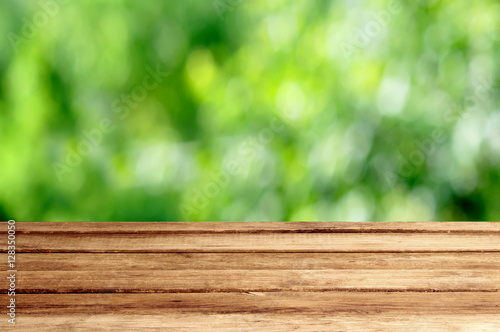 Empty wood table with garden summer bokeh outdoor theme backgrou