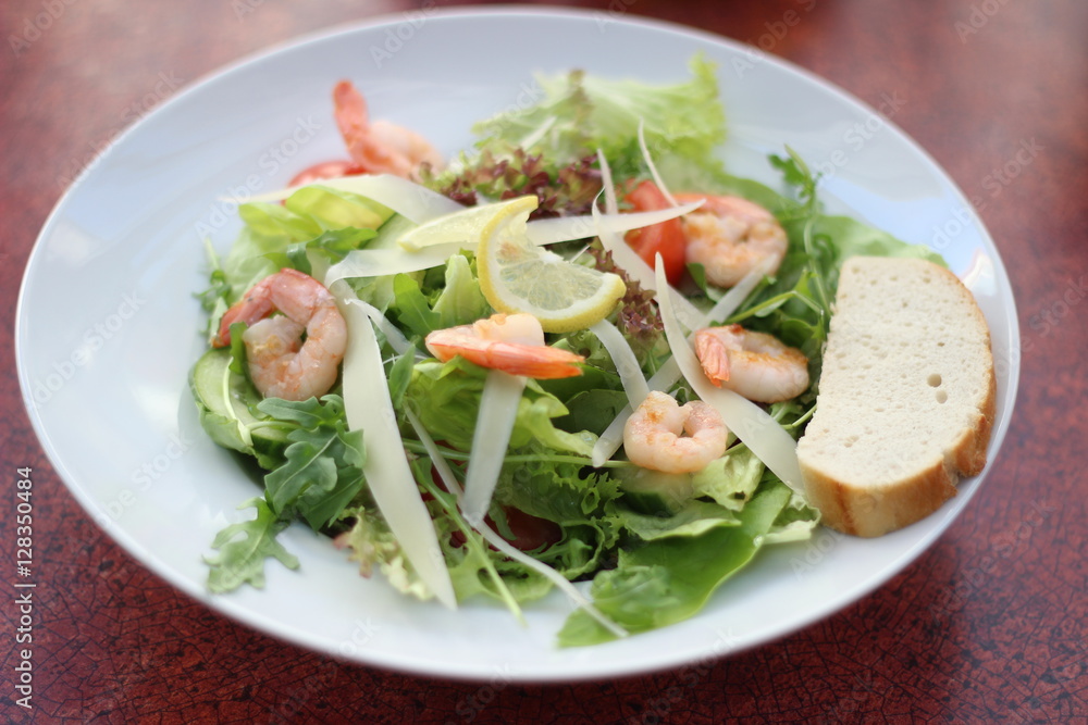 Restaurant food with fresh ingredients - salad with shrimps, parmesan and olive oil Restaurant food with fresh ingredients - salad with shrimps, parmesan and olive oil