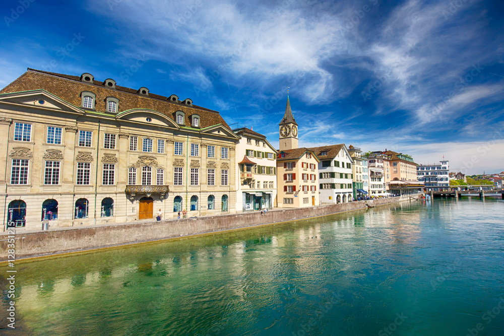 Beautiful view of the historic city center of Zürich with famous Fraumünster Church and swans on river Limmat on a sunny day with blue sky, Canton of Zürich, Switzerland.