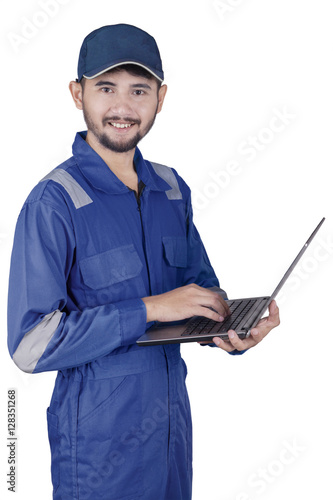 Arabian mechanic typing on laptop