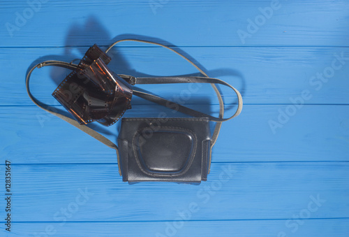 Wallpaper Mural Old Photo Camera and Filmstrip on Blue Wooden Background Torontodigital.ca