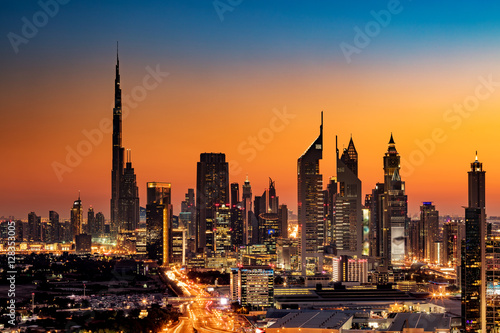 A beautiful Skyline view of Dubai, UAE as seen from Dubai Frame at sunset showing Burj Khalifa, Emirates Towers, Index Building and DIFC