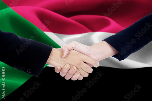 Negotiation handshake with flag of Sudan