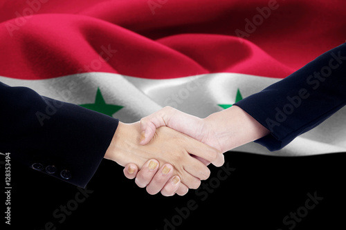 Negotiation handshake with flag of Syria