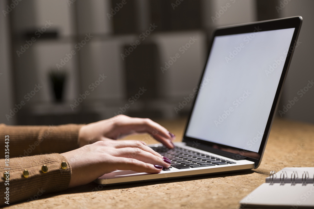 Close up of working woman's hands in a dark office. Close up of working woman's hands in a dark office.