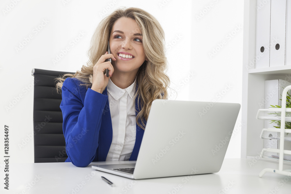 Cheerful woman in blue blazer on her phone Cheerful woman in blue blazer on her phone