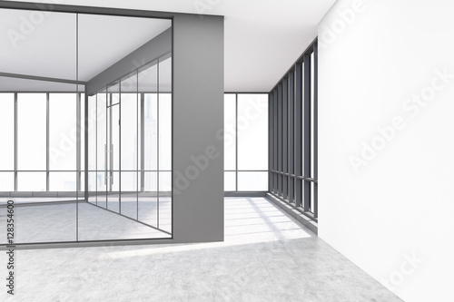 Empty office with glass and white concrete walls