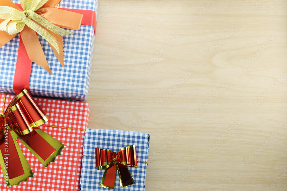 Obraz premium Gift box is placed on wooden floor.
