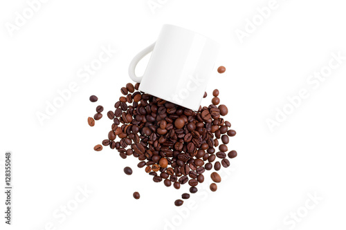 Overturned white mug with coffee beans, top view