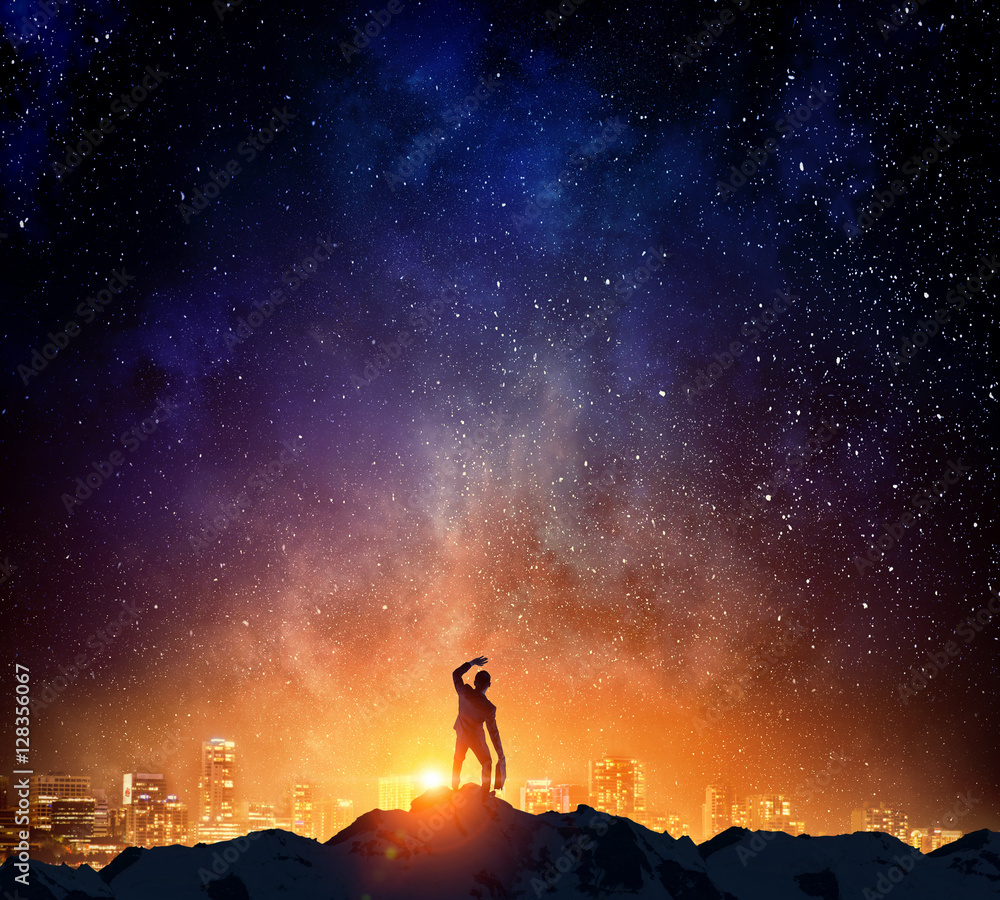 Fototapeta premium Businessman against starry sky . Mixed media