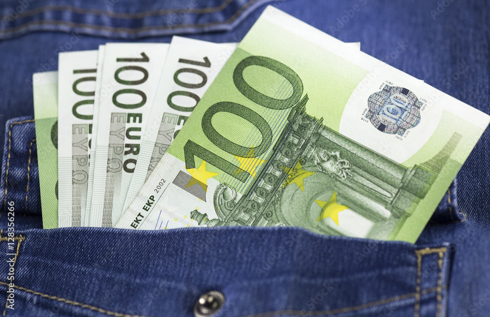 Several hundred euros banknotes stucking out the jeans pocket. Close up image. Several hundred euros banknotes stucking out the jeans pocket. Close up image.