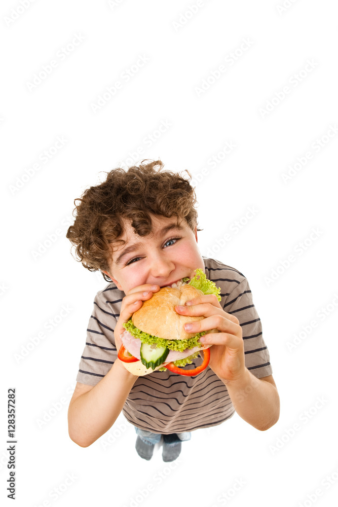 Boy eating healthy sandwich isolated on white background Boy eating healthy sandwich isolated on white background