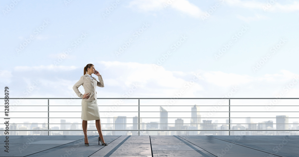 Businesswoman on building roof . Mixed media Businesswoman on building roof . Mixed media