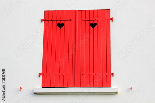 Red, wooden shutters with a heart