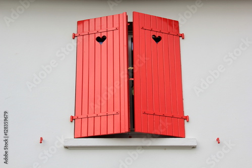 Red, wooden shutters with a heart