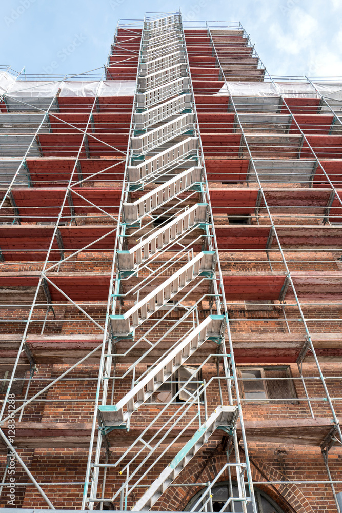 scaffolding at historic brick wall building currently under