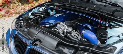Engine motor of blue car under hood © Ivan Kurmyshov