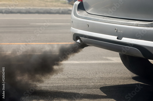 Air pollution from vehicle exhaust pipe on road