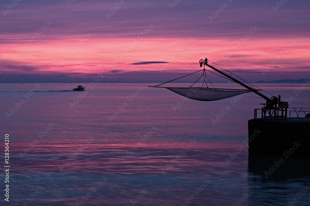 Wonderful magenta sunrise from the pier of Senigallia, Italy