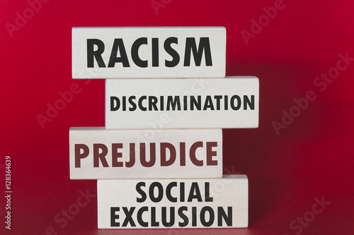 Racism, discrimination, prejudice and social exclusion message written on wooden tiles