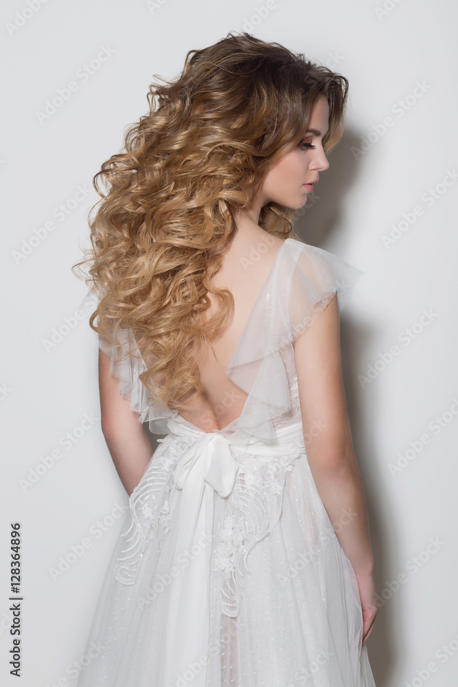 beautiful fashionable hairstyles for young girls beautiful delicate bride in a beautiful wedding dress on a white background in the studio beautiful fashionable hairstyles for young girls beautiful delicate bride in a beautiful wedding dress on a white background in the studio