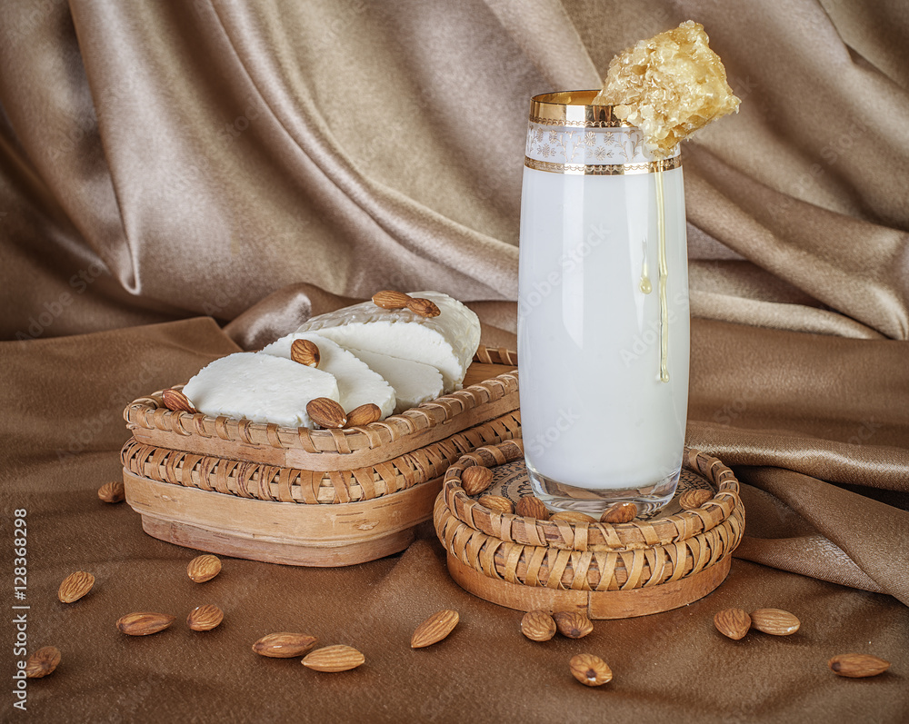 organic milk in glass honey, almonds and goat cheese