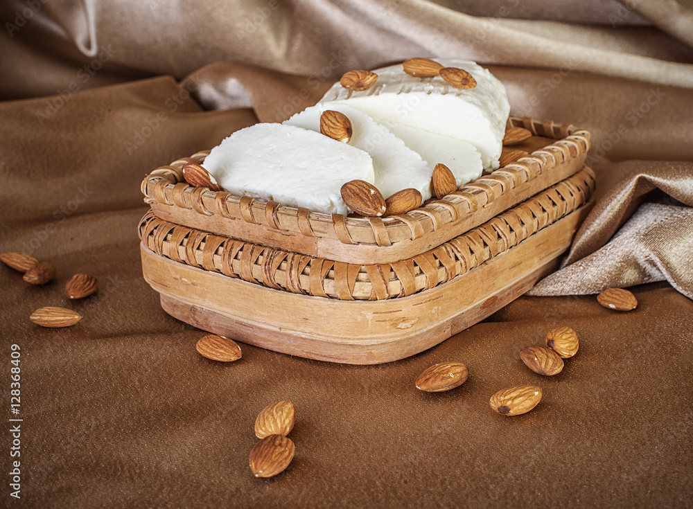 fresh soft cheese with almonds on wooden handmade boards