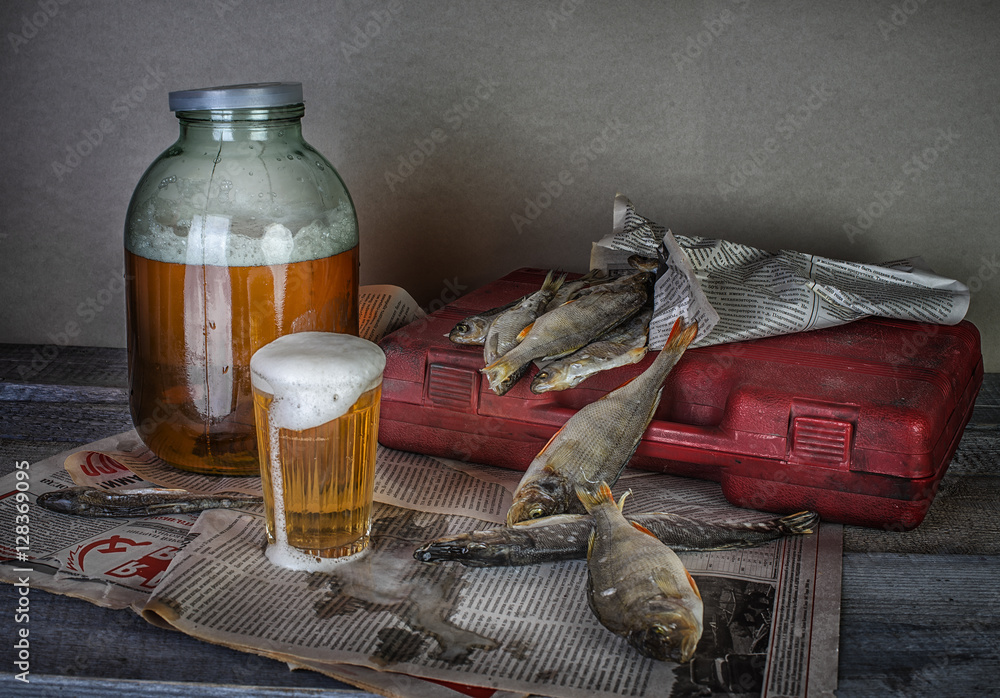 beer and dry fishes on wooden table