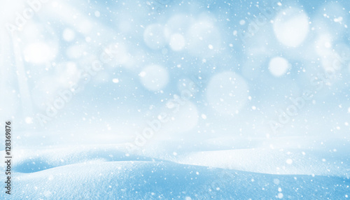 Winter background. Winter bright landscape with snowdrifts and falling snow. © Leonid Ikan