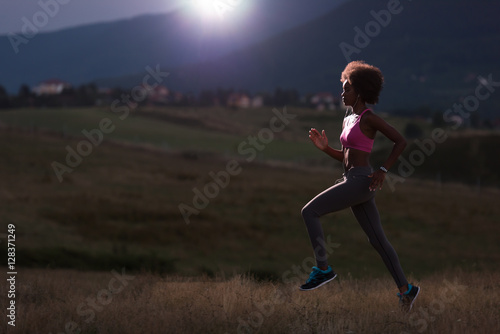 Young African american woman jogging in nature © .shock