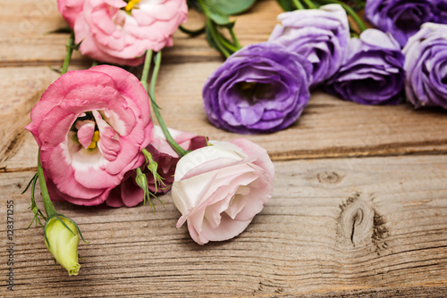 eustoma flowers on rustic wooden background