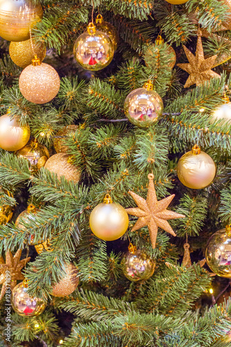 many Golden and yellow Christmas balls on the Christmas tree as a background and substrate