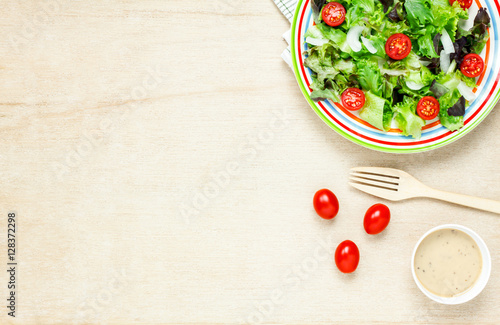 Top view cooking salad with sauce on wood table with copy space.