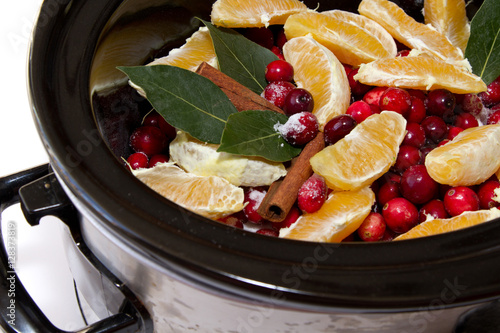 Картината върху платно Cranberry sauce with oranges, cinnamon and bay leaf simmering in