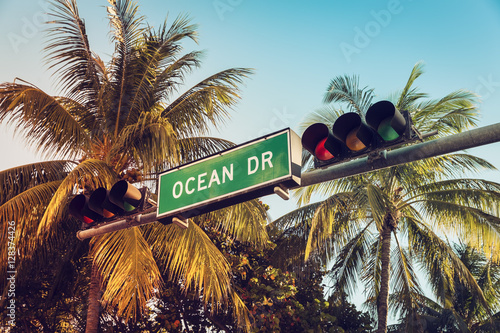 Ocean Drive street sign with palm trees, Miami photo