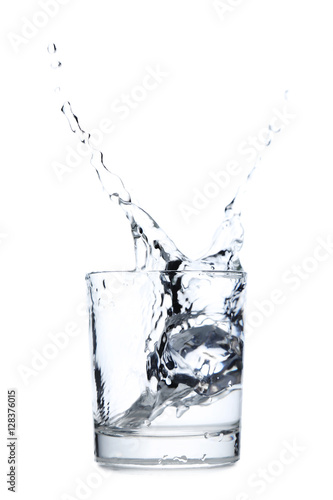 Glass of water with ice cube isolated on a white