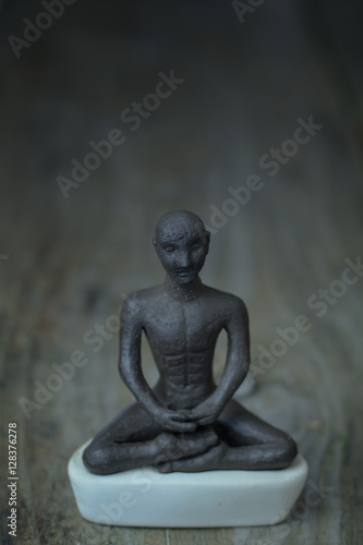 Silhouette young monk statue praying practicing yoga and meditate. Vipassana concept. Yoga  health life concept.