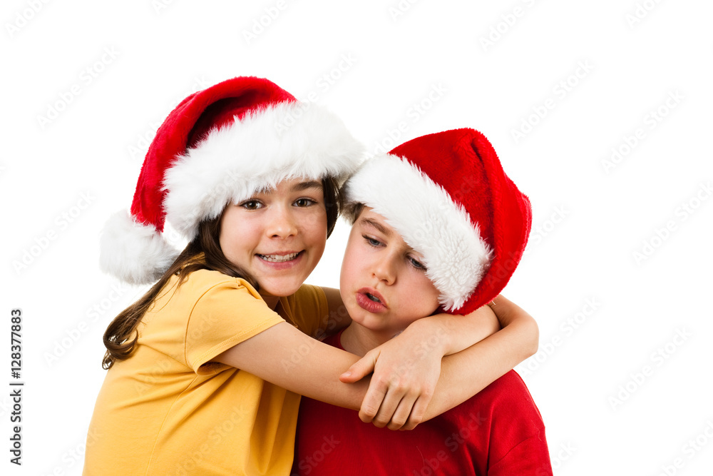 Christmas time - girl and boy with Santa Claus Hat Christmas time - girl and boy with Santa Claus Hat